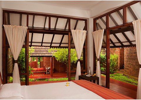Die Zimmer im SwaSwara Ayurveda Resort sind mit warmen Holztönen versehen