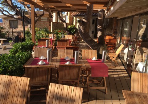 Die große, sonnendurchflutete Terrasse des Ayurveda-Restaurants im Centro de Salud Port Salvi bietet genügend Sitzplätze und einen hinreißenden Ausblick in die Natur.